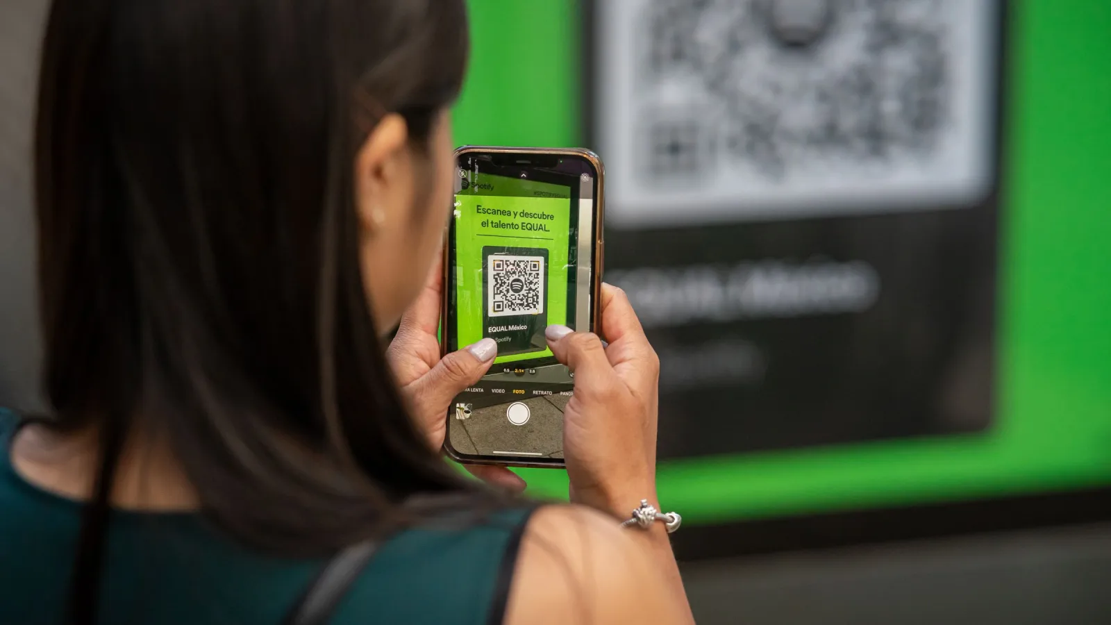 Woman scanning a QR code with her smartphone camera