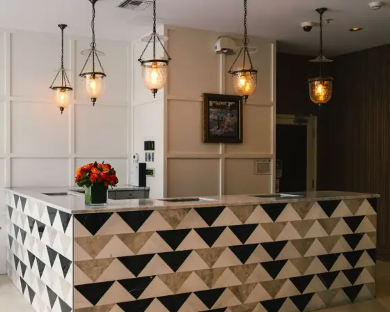 Hotel reception desk with marble counter and brass lanterns